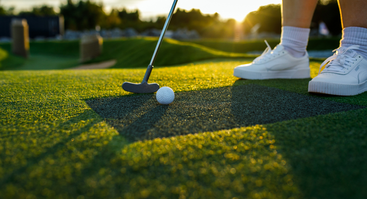 Spielerin puttet den Ball auf der Gulf Golf Anlage in Hooksiel